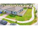 Overhead view of the property showcasing its fenced yard, landscaping, and corner lot location at 719 Tortugas St, Haines City, FL 33844