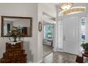 Inviting foyer with tiled floor and decoratively mirrored table at 7288 Winding Lake Cir, Oviedo, FL 32765