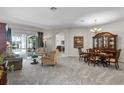 Spacious living and dining room with plush neutral carpet, and natural light at 7288 Winding Lake Cir, Oviedo, FL 32765
