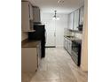 A modern kitchen with stainless steel appliances, granite countertops, and updated cabinetry at 767 Willie Mays Pkwy, Orlando, FL 32811
