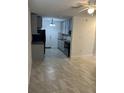 Open floor plan with tile flooring and a ceiling fan, seamlessly connecting to a modern kitchen at 767 Willie Mays Pkwy, Orlando, FL 32811