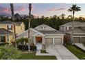Inviting home featuring a two-car garage, beautifully landscaped front yard, and a welcoming entrance at 9534 Piccadilly Sky Way, Orlando, FL 32827