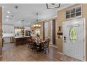 Inviting entryway and dining area with wood floors, pendant lighting, and a charming front door at 1022 Pinehurst Ct, Oviedo, FL 32765