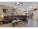 Comfortable living room featuring a leather sectional, decorative rug, and open access to the dining area at 1022 Pinehurst Ct, Oviedo, FL 32765