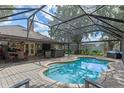 Inviting screened-in pool area with ample seating, perfect for outdoor entertaining and relaxation at 1022 Pinehurst Ct, Oviedo, FL 32765