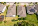 Aerial view of home with well-kept yard, trees, and neighboring homes at 11054 Cyrilla Woods Dr, Orlando, FL 32832