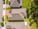 Birds eye view of a well maintained home with a dark shingle roof and greenery surrounding the property at 11054 Cyrilla Woods Dr, Orlando, FL 32832
