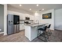 Modern kitchen with stainless steel appliances, a spacious island with seating, and sleek gray countertops at 1167 Celery Oaks Ln, Sanford, FL 32771