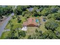Aerial view showcasing the property's pool, landscaping, and spacious yard at 12202 Rambling Oak Blvd, Orlando, FL 32832