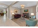 Comfortable living room with fireplace, stylish decor, and tile/wood flooring, creating a warm and inviting atmosphere at 12289 Prairie Plantation Way, Orlando, FL 32824