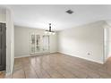 Open dining area with tile flooring, chandelier, and a view of the front yard at 140 Margate Mews, Longwood, FL 32779