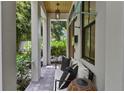 Cozy front porch with comfortable seating and a stylish pendant light, perfect for relaxing outdoors at 1429 Indiana Ave, Winter Park, FL 32789