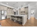 Spacious kitchen boasts stainless steel appliances, a large island with seating, and hardwood flooring at 1590 Harston Ave, Orlando, FL 32814