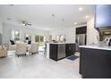 Modern kitchen with an island, stainless steel appliances, dark cabinets, and an open layout at 15998 Sw 33Rd Avenue Rd, Ocala, FL 34473
