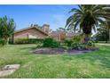 Landscaped front yard with lush grass and flowering plants at 169 Mallard Ln, Daytona Beach, FL 32119
