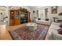 Inviting living room with plush couches, hardwood floors, a patterned rug, and large windows for natural light at 2002 Adair St, Ocoee, FL 34761