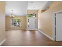 The living room features vaulted ceilings, hardwood floors and natural light at 2074 S Parkton Dr, Deltona, FL 32725