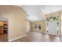 Bright living room boasts neutral walls, hardwood floors, and decorative lighting fixtures at 2074 S Parkton Dr, Deltona, FL 32725