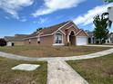 Cozy home with a well-maintained lawn, featuring a two-car garage at 2108 Shannon Lakes Blvd, Kissimmee, FL 34743