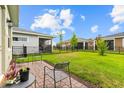 A cozy patio with outdoor seating overlooks the expansive, well-maintained backyard and neighboring homes at 2524 Datura Loop, St Cloud, FL 34772