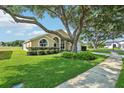 Inviting single-story home boasts lush green lawn, beautiful landscaping, and a spacious driveway at 2598 Ekana Dr, Oviedo, FL 32765