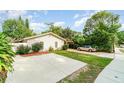 Inviting single-story home with a well-maintained front yard and a cozy carport, perfect for outdoor relaxation at 2825 Mayer St, Orlando, FL 32806