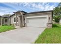 Attractive single-story home showcasing a clean two-car garage and modern front yard at 2908 Lingo Ln, Orlando, FL 32822