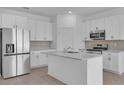 Modern kitchen featuring a large island, granite counters, and stainless steel appliances at 2908 Lingo Ln, Orlando, FL 32822