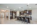 Spacious kitchen with granite counters, stainless appliances, and island with barstool seating at 2938 Bushmead Ct, Ocoee, FL 34761