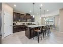 Large kitchen with a kitchen island, stainless steel appliances, breakfast bar, and eat-in kitchen at 2938 Bushmead Ct, Ocoee, FL 34761
