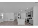 Modern kitchen featuring stainless steel appliances, a central island, and stylish pendant lighting at 305 Platform Ln, Debary, FL 32713