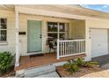 Inviting front porch with seating area, light paint and decorative front door at 3416 Grant Blvd, Orlando, FL 32804