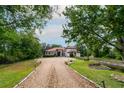 Sprawling single-story home with red tile roof, mature trees, and circular driveway at 3437 Coronet Ave, Orlando, FL 32833