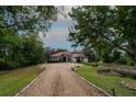 Spacious home with red tile roof, a long driveway, and mature landscaping at 3437 Coronet Ave, Orlando, FL 32833