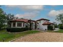 Beautiful single-story home with a tile roof, well-manicured lawn, and circular driveway at 3437 Coronet Ave, Orlando, FL 32833