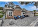 Stone patio with ample seating and a brick facade, perfect for outdoor enjoyment at 434 S Beach St, Ormond Beach, FL 32174