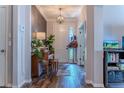 Inviting entryway with wood floors, piano, and coat rack, offering a warm welcome at 459 Millwood Pl, Winter Garden, FL 34787