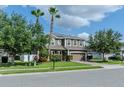 Beautiful two-story home boasting mature trees, lush landscaping, and a well-maintained lawn at 459 Millwood Pl, Winter Garden, FL 34787