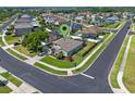 An aerial view of a single-Gathering home in a residential area, surrounded by other houses and lush trees at 570 Cascading Creek Ln, Winter Garden, FL 34787