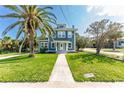 Charming two-story home with a landscaped lawn and inviting white-framed windows at 600 Bostwick Ave, Daytona Beach, FL 32118