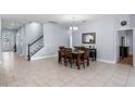 Spacious dining room with tile floors, chandelier lighting, access to the main entry and an adjacent room at 604 Fosters Grove Loop, Oviedo, FL 32765