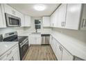 Modern kitchen with stainless steel appliances and sleek white cabinets at 6354 Hill Rd, Orlando, FL 32810