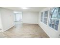 Bright living room with fresh paint, new flooring, and large windows at 6354 Hill Rd, Orlando, FL 32810