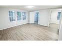 Bright living room featuring new flooring and fresh paint throughout at 6354 Hill Rd, Orlando, FL 32810