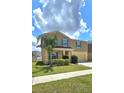 Lovely home featuring manicured lawn, a welcoming driveway, and charming blue shutters at 651 Taft Dr, Davenport, FL 33837