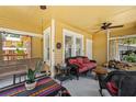 Relaxing front porch with a swing, wicker furniture, ceiling fans, and striped blankets at 706 Hillcrest St, Orlando, FL 32803