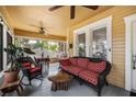 Spacious porch with wicker seating, ceiling fans, and views of the landscaped front yard and swing for relaxing at 706 Hillcrest St, Orlando, FL 32803