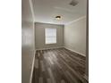 Bedroom features wood-look floors, a ceiling light, and a window at 7147 Yacht Basin # 132, Orlando, FL 32835
