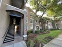 Complex features well-maintained landscaping and covered stairwells at 7147 Yacht Basin # 132, Orlando, FL 32835