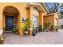 Inviting front porch with decorative tile, plants and decor at 7951 Chediston Cir, Orlando, FL 32817